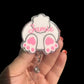 A personalized badge reel with a white and pink bunny butt design, and the name 'Jamie' printed on it.