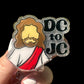 A badge reel with an illustration of a character and the text 'DC to JC' on it.