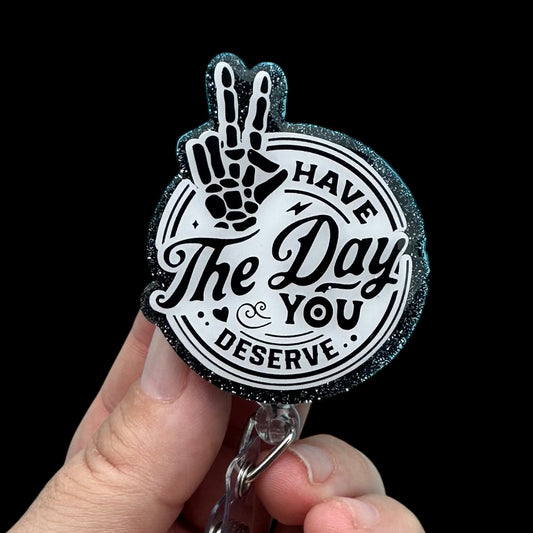 Keychain with peace sign and motivational quote.