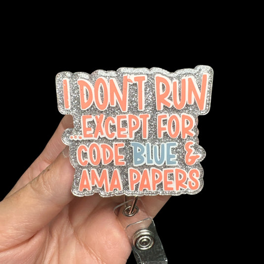 A hand holding a retractable badge reel with the text 'I DON'T RUN EXCEPT FOR CODE BLUE & AMA PAPERS' printed on it.