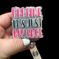 A badge reel with the text 'I'M FINE IT'S JUST MY FACE' in pink and silver colors on a black background.