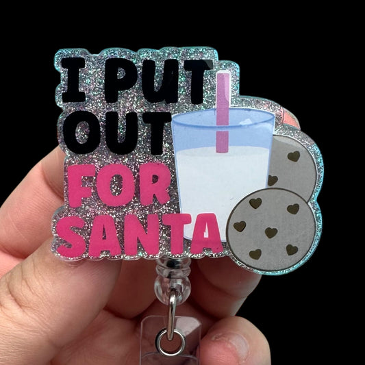Badge holder with 'I Put Out For Santa' text, milk and cookie charms 