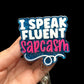 A badge reel with the phrase 'I SPEAK FLUENT SARCASM' written in stylized lettering, predominantly in blue and pink colors.