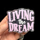 A badge reel holder with the text 'LIVING the DREAM' printed on it.