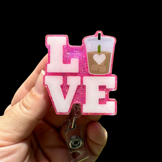 Pink glittery 'LOVE' badge holder with a drink icon 