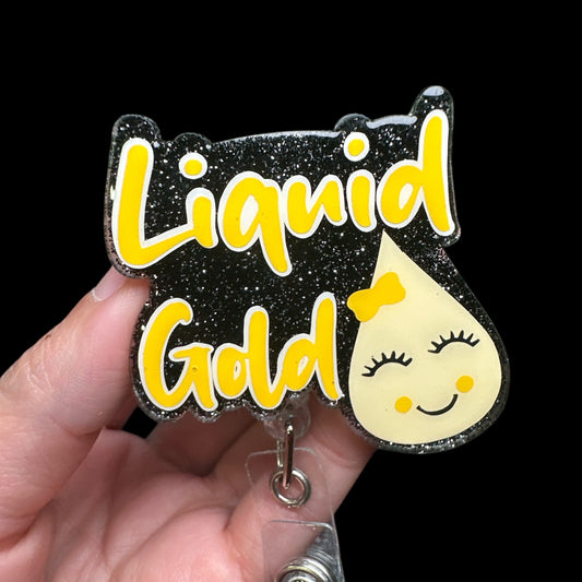 A badge reel with a black and yellow design, featuring text and a smiling sun illustration, attached to a clip.