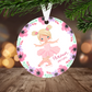 Christmas ornament with a ballerina design and floral elements, hanging on a Christmas tree.
