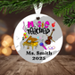 Round Christmas ornament with music-themed design and text 'Music Teacher Ms. Smith 2025' on a Christmas tree.