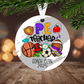 Decorative Christmas ornament for a PE teacher with sports-themed design, hanging on a tree.