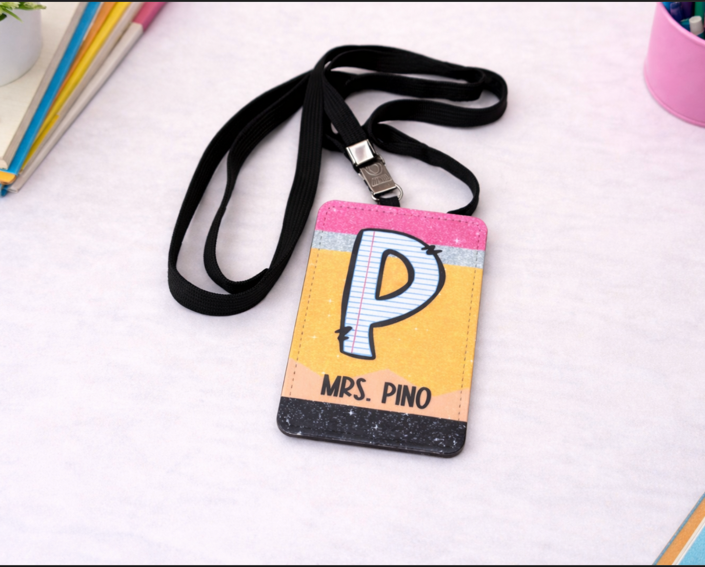 Colorful lanyard with a badge holder featuring a letter