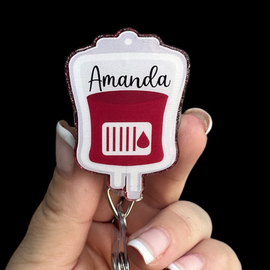 A  badge reel designed to look like a phlebotomy blood bag with the name 'Amanda' printed on it.