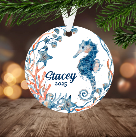Decorative ornament with seahorse and coral design, featuring the name and year