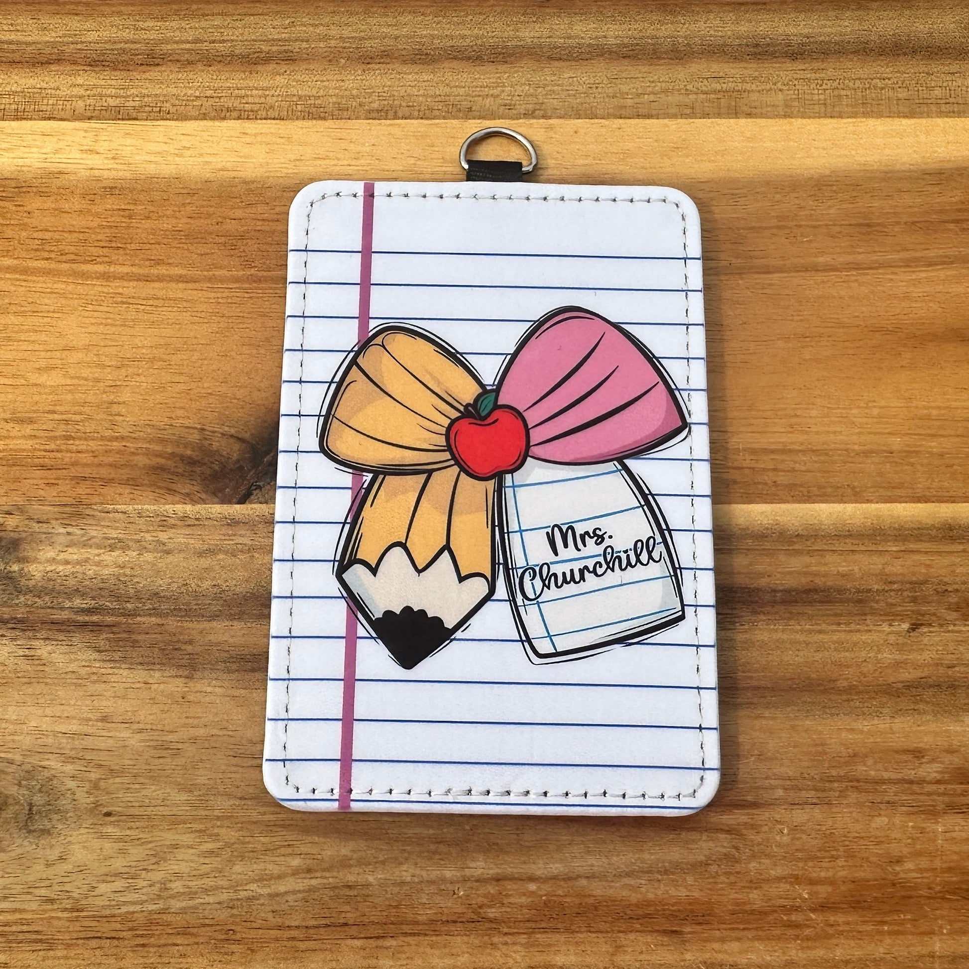 Card holder with a pencil and notebook design