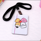 Notebook-style lanyard holder with a pencil and bow design 