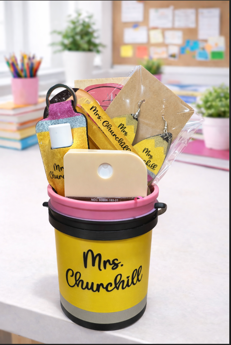 Yellow bucket filled with stationery items on a desk.